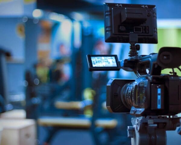 Broadcast camera with monitor set up in a gym environment.
